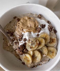 a white bowl filled with oatmeal and bananas