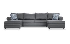 a gray sectional couch with pillows on the top and bottom corner, in front of a white background