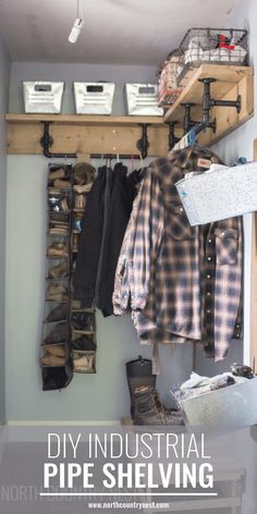 an industrial pipe shelving unit with lots of clothes hanging on the wall and shelves