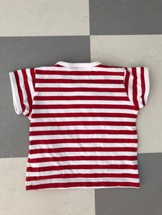 Cute T-shirt from Finnish company Marimekko. This one is if you want to match yourself and your child. 100% cotton. Marked with size 60 cl and fits children up to approx 12 months. Very good condition. Clear colors. Striped in Red and White. ♪♫♬ Don't hesitate to ask for measurements. Cotton Tops With Vertical Stripes And Short Sleeves, Cotton Shirt With Contrast Stripes And Short Sleeves, Cotton Tops With Three Stripes And Short Sleeves, Cute Striped Cotton Tops, Cute Red Cotton Top, Cotton Short Sleeve Tops With Contrast Stripes, Striped Cotton Crew Neck Shirt, Red Family Matching Short Sleeve Shirt, Red Short Sleeve Shirt For Family Matching