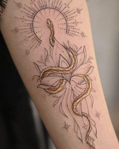 a woman's leg with a tattoo on it and an image of a snake