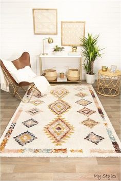 a living room area with a rug, chair and potted plant