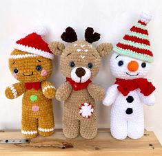 three crocheted teddy bears are standing next to each other wearing christmas hats and scarves