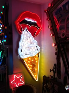 an ice cream cone is lit up with neon lights