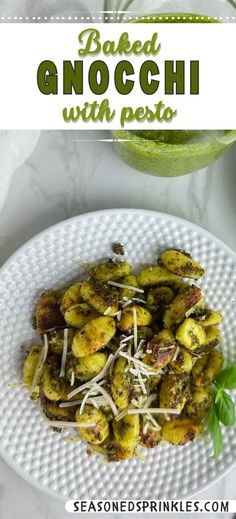 baked and noggi with pesto on a white plate next to a watermelon