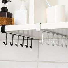 a shelf with hooks and cups on it