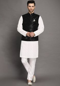 Faux Georgette Kurta in White.This Readymade attire is Enhanced with Buttons, Resham and Sequins Work. Crafted in Chinese Collar Neck and Full SleeveAvailable with Cotton Pant in White and a Velvet Nehru Jacket in BlackDo note: Brooch and Footwear shown in the image is for presentation purposes only. Half to one inch may vary in measurement. (Slight variation in actual color vs. image is possible)  We sell all kinds of menswear. Mens Kurta | Mens Kurta Pajama | Mens Sherwani | Mens Sherwani Sets Festive White Outerwear With Chikankari Embroidery, Elegant Black Nehru Jacket With Chikankari Embroidery, Black Festive Set With Embroidered Sleeves, Festive Black Set With Embroidered Sleeves, Black Sets With Embroidered Sleeves For Festive Occasions, White Sets For Fall Wedding, White Wedding Sets For Fall, Traditional Black Nehru Jacket With Stand Collar, White Embroidered Fitted Nehru Jacket