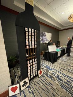 a man standing next to a table with cards on it