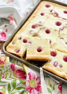 raspberry slab cheesecake in a pan with a pink ribbon around the edges