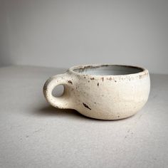 a white cup sitting on top of a table