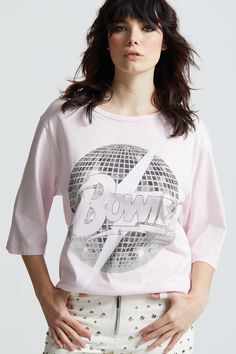 Keep the party going with David Bowie! Our vintage inspired tee features David Bowie's iconic logo with a bolt and disco ball graphic. This oversized 3/4 sleeve tee is completed with soft cotton fabric, a crew neckline, and distressed graphics for the perfect chic vintage tee aesthetic. Details Style #301397 Color: Crystal Pink David Bowie Disco Oversized 3/4 Sleeve T-Shirt 100% Cotton Care/Import Machine Wash Cold, Tumble Dry Low Designed and Finished in Los Angeles Measurements Model is wearin Disco Ball Graphic, Ball Aesthetic, Vintage Disco, Logo With A, Disco Era, Oversized Graphic Tee, Iconic Logo, Chic Vintage, Vintage Tee