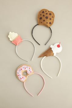 three headbands with donuts and ice cream on them, one has a cookie