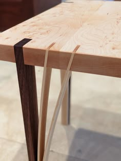 a close up of a wooden table with some wood sticks sticking out of the top