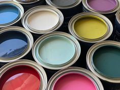 many different colors of paint in cans