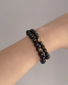 Each smooth, lustrous bead shimmers with an enchanting golden sheen, creating a captivating play of light. The deep, rich black color of the obsidian provides a striking contrast, making this bracelet a truly mesmerizing accessory. Whether worn alone for a touch of understated sophistication or layered with other pieces for a more dramatic statement, this bracelet is the perfect addition to any jewelry collection, allow its spiritual essence to accompany you on your quest for inner harmony and e