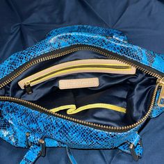 Juicy Couture Snake Print Bag. In The Color Blue With Hood Accents. Never Used, In Like New Condition. Shoulder Strap Top Zip Closure Interior Zip Pocket With 2 Slip Pockets Originally $248 Blue Top Handle Bag With Zipper Closure, Trendy Blue Satchel Shoulder Bag, Blue Tote Shoulder Bag With Zipper Closure, Trendy Blue Top Handle Shoulder Bag, Blue Top Handle Shoulder Bag With Zipper Closure, Blue Shoulder Bag With Zipper Pocket, Blue Shoulder Bag With Zipper Closure And Top Handle, Blue Backpack Shoulder Bag With Zipper Pocket, Casual Blue Satchel With Zipper Closure