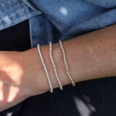 Whether worn alone for a touch of understated luxury or stacked with other bracelets for a bold statement, these Ball Bead Bracelets add a touch of glamour to any outfit, for any occasion. Made to be worn in the pool, shower, ocean, or wherever your bohemian adventures take you. Waterproof | Tarnish Free | Hypoallergenic Classic 3mm beads Options: 14K gold filled, Sterling Silver, or Two Tone High Performance Elastic Made in Miami Timeless Tarnish Resistant Gold-tone Bracelet, Elegant 14k Gold-filled Bracelets With 8mm Beads, White 14k Gold-filled Round Beaded Bracelet, Gold-tone Brass Bracelets, Tarnish Resistant, Gold-tone Tarnish Resistant Brass Bracelets, Jewelry Gift Guide, Fine Gold Jewelry, Gemstone Meanings, Jewelry Post