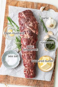 an uncooked steak on a cutting board with spices and seasonings