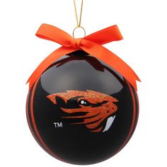 a black ornament with an orange ribbon on it