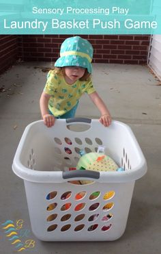 a young child playing in a laundry basket with text overlay that reads, how to teach toddlers to play laundry basket push game