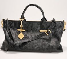 Make this soft leather beauty your everyday handbag. Goldtone accents elevate this casual style. The lined interior features multiple pockets for organization, and the dangle accessory provides a glam finishing touch. From Vince Camuto. Fall 2024 Handbag Trends, 2023 Wishlist, Soft Leather Purse, Trendy Purses, Everyday Handbag, Popular Handbags, Pocket Books, Bag Women Fashion, Crossbody Handbags