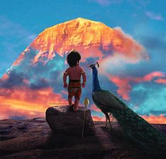 a child standing on top of a rock next to a peacock in front of a mountain