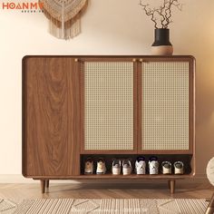 a wooden cabinet with several pairs of shoes on it in front of a wall hanging