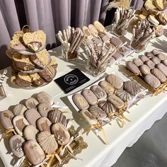 a table topped with lots of desserts and cookies