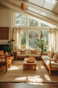 a living room filled with lots of furniture under a skylight next to a window