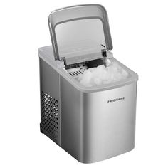 a small ice maker with an open lid on the top and ice cubes in it