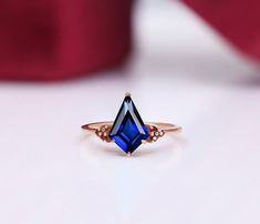 BeckyB Jewelry offers fine jewelry in solid gold and gold-plated 925 sterling silver Metal type - 925 sterling silver Main Gemstone  - Lab Created Blue Sapphire Gemstone Shape:- Kite Gemstone Size:- 12X8 mm Gemstone Wt - 2.75 Carats Stamp - 925/14K/18K Red Garnet Accents Plating - 14k rose gold vermeil Realization - Typical Handmade Occasions - engagement, wedding, birthday, anniversary, Easter gift, etc. We can make this particular ring with all types of semiprecious and precious gemstones [as Sapphire Rings With Diamond Cut For Gift, Rose Gold Sapphire Ring In Sterling Silver, Fine Jewelry Rose Gold Sapphire Ring In Sterling Silver, 14k Rose Gold Rings With Accent Stones For Gift, Red Sapphire Birthstone Ring In 14k Gold, 14k Rose Gold Gemstone Rings As Gift, Fine Jewelry Rose Gold Sapphire Open Ring, Rose Gold Sapphire Ring As Gift, 14k Rose Gold Sapphire Ring Gift