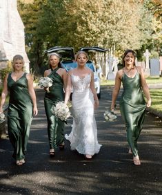 bridesmaids in green dresses walking down the street