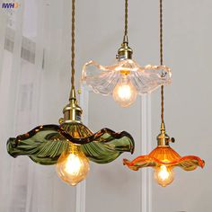 three light fixtures hanging from a ceiling in a room