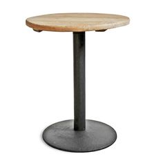 a round wooden table sitting on top of a metal base