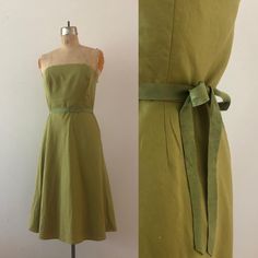 A fabulous green day dress by Ann Taylor from the early 2000s. It zips up the center and has a structured, secure lining. The included green waist belt ties into a decorative bow, completing the look. era: y2K  tag size: 8 meausrements: bust 36" waist 31" hips - up to 45" total length 35.5" brand: Ann Taylor condition: good vintage condition Fitted Green A-line Strapless Dress, Green Strapless Dress With Fitted Bodice, Summer Formal Strapless Fitted Dress, Green Dress With Fitted Bodice And Straight Neckline, Fitted Strapless Dress With Straight Neckline For Garden Party, Green Fitted Strapless Midi Dress, Spring Fitted Knee-length Strapless Dress, Fitted Knee-length Strapless Dress For Spring, Green Fitted Strapless Dress