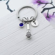 a silver keychain with a blue stone on it