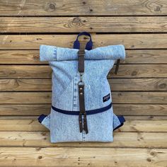 This recycled backpack is perfect for walking, sightseeing, hiking or going to work. This handmade bag makes it easy to carry everything you need on a busy or lazy day. The material of the backpack is recycled, high-quality denim jeans. Of course, the jeans were properly cleaned. The lining and interior are made of strong canvas. Inside there is a large pocket with a zipper. The roll-top part closes with a real leather strap. This handmade product was made for you with great love. The size of th Jeans Backpack, Jean Backpack, Recycled Jeans, Top Backpacks, Roll Top, Lazy Day, Handmade Bag, Great Love, Backpack Purse