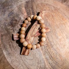 In Spanish, Palo Santo translates to "Holy Wood" and it grows in the coastal regions of South America. These bracelets are made of 100% palo santo wood and are very fragrant when worn. Spiritual Natural Wood Beaded Bracelets, Holistic Wooden Beads Bracelets For Meditation, Natural Wooden Beads Spiritual Bracelet, Rustic Wooden Beads Bracelet, Holistic Wooden Beads Healing Bracelet, Adjustable Wood Spiritual Bracelets, Adjustable Wooden Spiritual Bracelets, Adjustable Wood Bracelets For Meditation, Natural Wood Beaded Bracelets As Gift