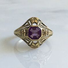 Details: Victorian 14K gold Art Deco amethyst ring circa 1930's. Beautiful deco design, with leaf inspired pattern. The lovely amethyst measures 6.7mm x 6.7mm, and sits about 5.5mm from the finger. The setting measures 15.4mm from top to bottom. The ring is in excellent condition. Please ask all necessary questions prior to placing an order. Measurements: The size is 7 US and can be sized for a fee. Condition: The overall all condition of this ring is excellent condition and the stone is securel Luxury Art Deco Purple Amethyst Ring, Antique 14k Gold Amethyst Ring, Classic Amethyst Ring Stamped 14k, Art Deco Oval Amethyst Ring, Purple Amethyst Hallmarked Signet Ring, Gold Oval Amethyst Ring In Art Deco Style, Art Deco Oval Purple Amethyst Ring, Art Deco Purple Amethyst Ring For Formal Occasions, Art Deco Purple Amethyst Ring For Anniversary