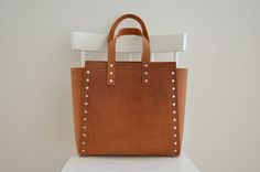 The Squareforma Tote in Brown. Minimalist and simple, capacious and elegant handmade leather bag will fit everything you need. It is perfect Brown Minimalist, Handmade Leather Bag, Bag Minimalist, Minimalist Bag, Brown Leather Totes, Brown Bag, Black Leather Tote, Biker Leather