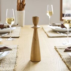 a wooden table topped with plates and glasses of wine