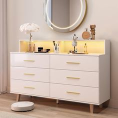 a white dresser with two sinks and a round mirror