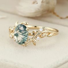 a gold ring with an aqua blue stone and white diamonds on it's side