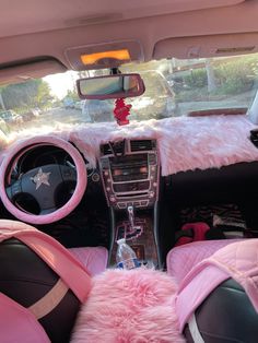 the interior of a car with pink fur on the dash board and steering wheel cover