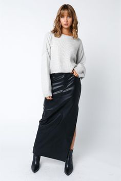 Unleash your inner fashion rebel in our Black Faux PU Leather Slit Maxi Skirt. This stunning piece features a sleek faux leather material that adds edge to any outfit. The daring slit adds a touch of sexiness, while the maxi length adds an air of sophistication. Perfect for a night out or a bold daytime look. Belt loops Front button and zipper closure Front and back pockets Front leg slit Faux PU leather material Midi Skirt Fall, Pu Skirt, Pu Fabric, Jumpsuit Shorts Rompers, Tiered Maxi Dress, Edgy Look, Striped Cardigan, Unique Designers, Romper With Skirt