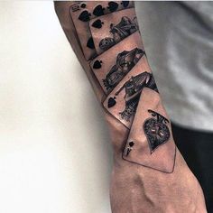 a man's arm with playing cards on it