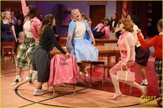 a group of women standing on top of a stage