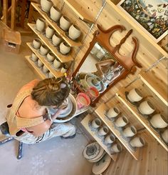 a woman working on pottery in a shop