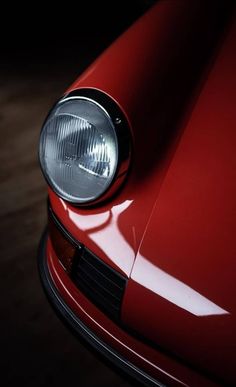 the front end of a red sports car