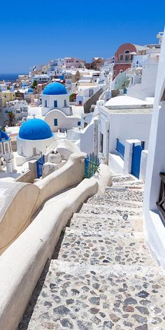 a bench sitting on the side of a building next to a blue and white dome